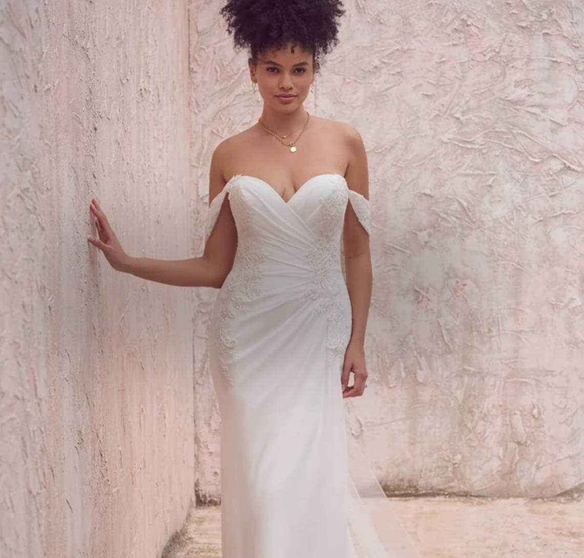 Model wearing a white gown. Mobile image
