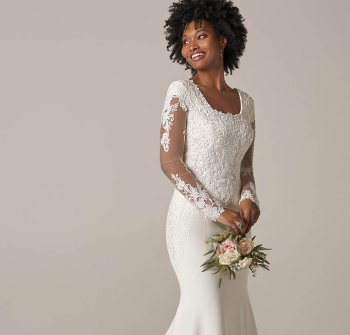 Model wearing a white gown by Rebecca Ingram