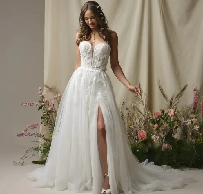 Model wearing a white gown by Rebecca Ingram