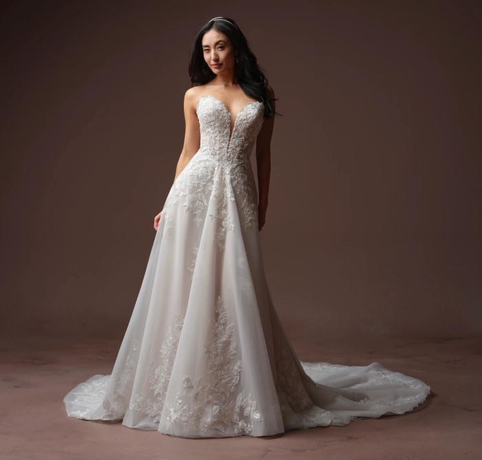Model wearing a white gown by Rebecca Ingram